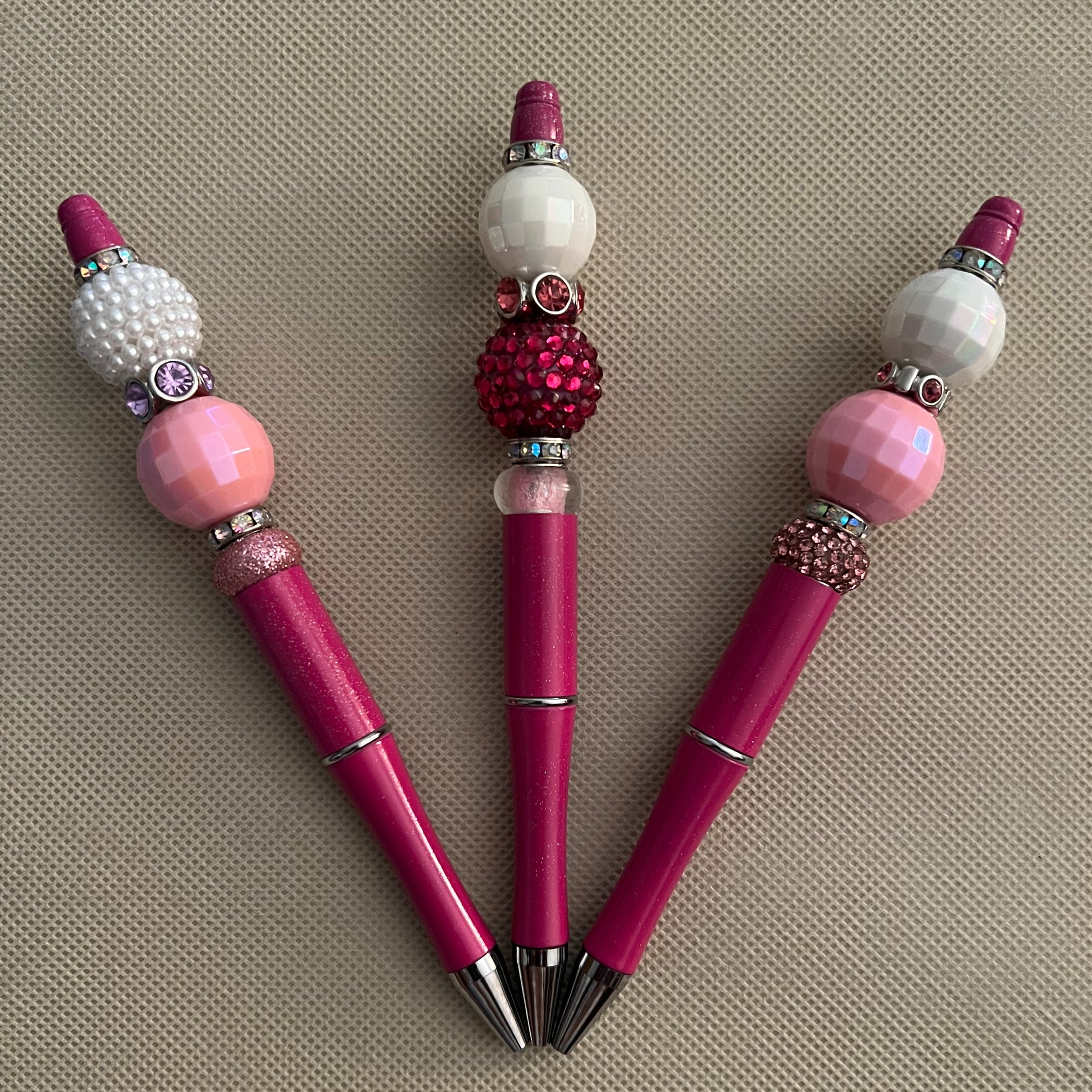 Group of one-of-a-kind pink beaded pens.
